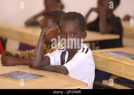 TORO, SENEGAL - 4 FEBBRAIO: Un scolaro in classe con una lavagna alla sua scrivania a scuola il 4 febbraio 2020 a Toro, Senegal (Foto di Peter van Foto Stock