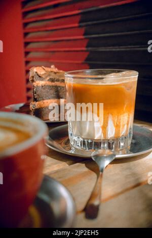 Un colpo verticale di un caffè Dalgona ghiacciato su un tavolo di legno Foto Stock