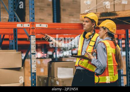 cargo magazzino lavoratori uomini e donne caucasici che lavorano insieme ingegnere di squadra Foto Stock