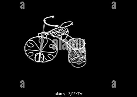 Bicicletta a filo bianco con cesto su sfondo scuro Foto Stock