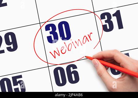 30th giorno del mese. WEBINAR di testo con scrittura a mano e cerchiatura della data del calendario. Data del webinar sul calendario o sull'agenda. Concetto giorno dell'anno. Foto Stock