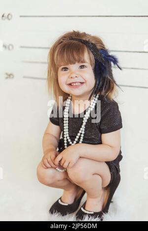 Bambino affascinante in costume gangster alla stazione di polizia Foto Stock