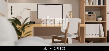 Confortevole casa scandinava spazio di lavoro interni design con PC computer desktop mockup su tavolo di legno, moderna sedia in legno, libreria di legno e arredamento Foto Stock