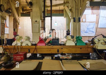 Gli ufficiali che presbano i telefoni nella grande sala mappa. Al Winston Churchill War Rooms Museum di Londra, Inghilterra, Regno Unito. Foto Stock