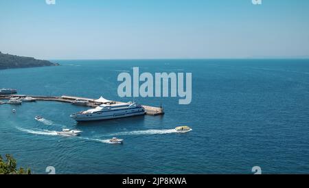 Porto di Sorrento Italia con navi che viaggiano verso la costiera amalfitana e l'isola di Capri, anche in immagine è una barca a pagamento che porta i passeggeri alle navi da crociera. Foto Stock