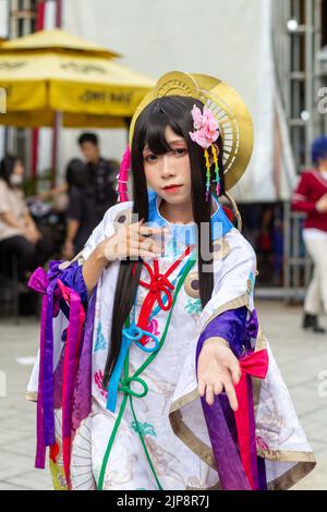 A vertical of an Asian female dressed like an anime character at Cosplay Festival in Ho Chi Minh, Vietnam Stock Photo