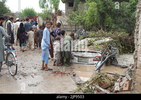 Nangarhar, Afghanistan. 15th ago, 2022. Le persone sono viste nella zona colpita dalle inondazioni nella provincia di Nangarhar, Afghanistan, 15 agosto 2022. Almeno otto persone sono state uccise e altre sei sono state ferite lunedì a causa di forti piogge e inondazioni improvvise nella provincia orientale afghana di Nangarhar, ha dichiarato un funzionario locale. Credit: Aimal Zahir/Xinhua/Alamy Live News Foto Stock