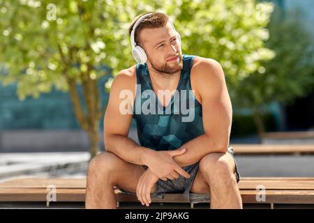 uomo in cuffia che ascolta musica all'aperto Foto Stock