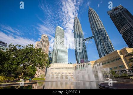 Kuala Lumpur, Malesia - 13 agosto 2022: Il Parco KLCC con lo spettacolo delle fontane di fronte alle torri Petronas. Lunga esposizione con acqua setosa j Foto Stock