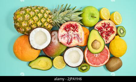 Composizione di frutta tropicale estiva su sfondo ciano pastello. Giacitura piatta. Concetto esotico Foto Stock