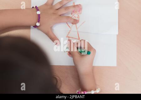 Bambine che si siedono nella scuola elementare disegnando su carta Foto Stock