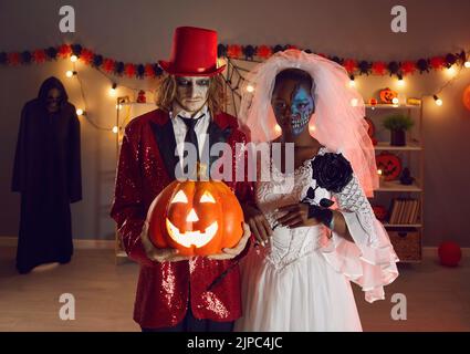 Spoky Halloween ritratto di uomo e donna creepy che sono vestiti come sposa morta e joker. Foto Stock