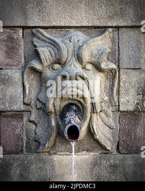 STOCCOLMA, SVEZIA - 31 LUGLIO 2022: Questa pompa fontana, con le gargoyles che guardano i beccucci, funziona ancora ed è una fonte di acqua fresca e pulita. Foto Stock