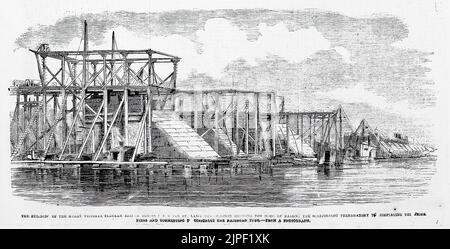 La costruzione del grande Victoria Bridge attraverso il fiume San Lorenzo - Sezione che mostra la modalità di sollevamento del ponteggio preparatorio a completare i moli di pietra e iniziare a costruire il tubo ferroviario (1860). Illustrazione del 19th° secolo dal quotidiano illustrato di Frank Leslie Foto Stock