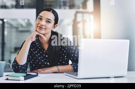 Sia sempre positivo nell'ambiente di lavoro. Una giovane donna d'affari attraente nel suo ufficio. Foto Stock