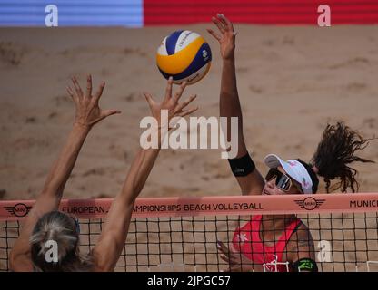 Monaco, Germania. 18th ago, 2022. Pallavolo/Spiaggia: Campionato europeo, Donne, Re Corte: Böbner/Verge-Depre (Svizzera) contro Walkenhorst/Lippmann (Germania). Zoe Verge-Depre (r) dalla Svizzera colpisce il pallone sul blocco di Louisa Lippmann dalla Germania. Credit: Soeren Stache/dpa/Alamy Live News Foto Stock