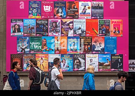 Persone che camminano per i poster del Festival della fringe di Edimburgo fuori dalla palloncino dorato su Chambers Street, Edimburgo, Scozia, Regno Unito. Foto Stock