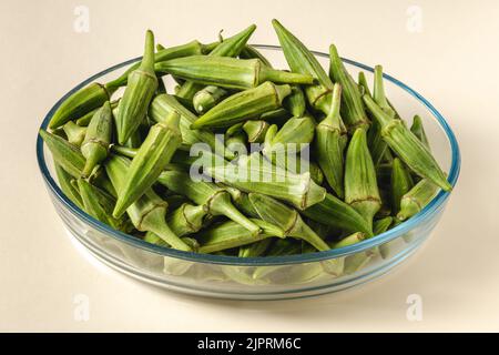 Okra crudo fresco in una ciotola di vetro. Concetto di alimentazione sana Foto Stock