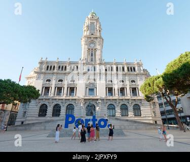 Il municipio di Câmara, alla fine di Avenida dos Aliados (viale degli Alleati). I turisti scattano foto davanti al grande cartello blu di Porto. Foto Stock