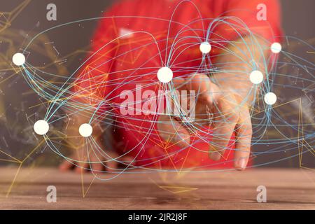 La mano tocca i punti collegati l'uno all'altro. Rete. Foto Stock