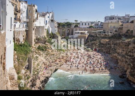 l'affollata spiaggia di polignano a mare sulla costa adriatica puglia italia Foto Stock