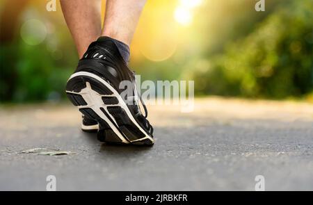 Gambe di un pareggiatore in scarpe da primo piano nel parco Foto Stock
