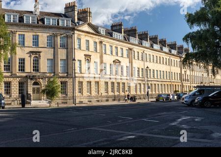 Great Pulteney Street e la sua terrazza illuminata dal sole, case cittadine georgiane d'epoca, Città di Bath, Somerset, Inghilterra, Regno Unito Foto Stock