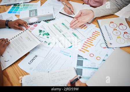 Tabella riportata sopra con documenti finanziari, grafici e big data durante una riunione di lavoro di squadra con il team di contabilità o marketing che discute di budget, strategia o crescita Foto Stock