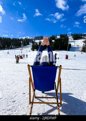 Foto di una sciatrice seduta sulla pista di sci riposante attività di svago estrema e di stile di vita attivo. Sciatore femminile su un pendio in montagna. Sport invernale Scratere di campagna nelle Alpi Foto Stock