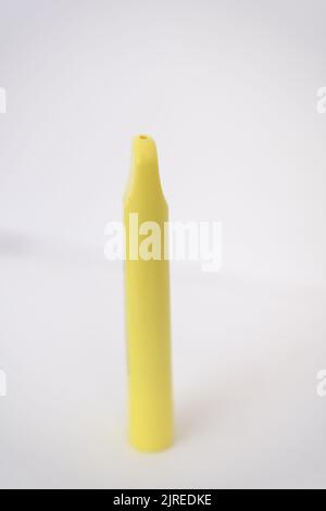 Sigaretta elettronica monouso gialla in mano femminile. Sfondo