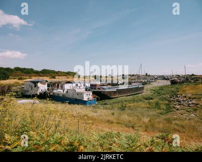 Le case galleggianti con bassa marea in Oyster Creek a Canvey Island, Thames Estuary, Essex Inghilterra UK Foto Stock