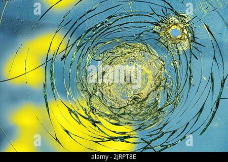 Spaccature nel vetro da un proiettile sulla bandiera dell'Ucraina Foto Stock