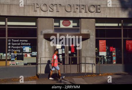 Londra, Regno Unito. 26th agosto 2022. Un lavoratore postale sulla linea del picket cammina oltre l'ufficio postale chiuso di Mount Pleasant mentre migliaia di impiegati della posta e dell'ufficio postale reali in tutto il Regno Unito cominciano il loro sciopero sopra la paga. Credit: Vuk Valcic/Alamy Live News Foto Stock