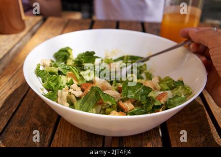 Una ciotola di Caesar insalata con lattuga, crostini e pancetta Foto Stock