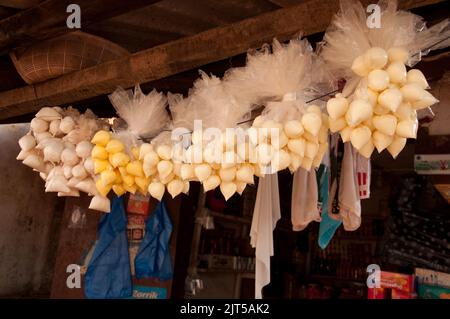 Piccoli sacchi di zucchero, burro e maionese, alimentari, Zorzor Town Centre, Lofa County. Liberia, Africa, appesa a un rafter Foto Stock