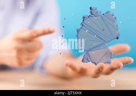 Una mappa tedesca resa 3D che si volava in mano all'uomo Foto Stock