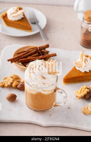 Latte speziato di zucca condito con panna montata e spolverato con cannella Foto Stock