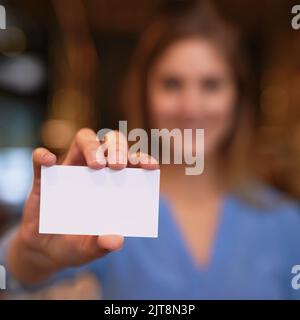 Ecco i dettagli. Ritratto ritagliato di una giovane donna irriconoscibile che tiene in mano un biglietto da visita vuoto. Foto Stock