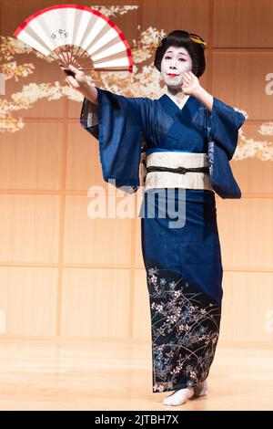 Una geisha giapponese che indossa un kimono, esegue una tradizionale danza dei tifosi presso il Santuario di Kanda Myojin, a Chiyoda, Tokyo, Giappone. Foto Stock