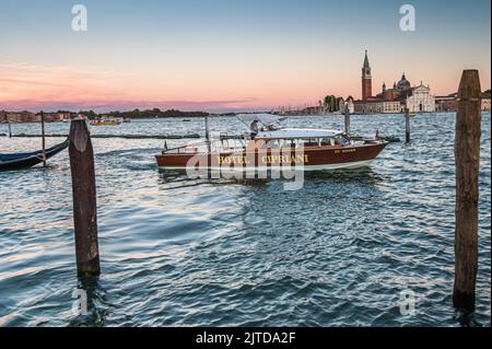 Il taxi privato dell'Hotel Cipriani si trova all'ingresso del Canal Grande di fronte all'isola della Giudecca. Inizialmente annunciata per giugno 2022, la tassa di ingresso per i viaggiatori di un giorno a Venezia sarà applicata solo a partire dal 16° gennaio 2023. Stordito dalla pandemia del 19 nel 2021, dalla fine delle restrizioni sanitarie in Italia nel 2022 fino a 110.000 giorni di turisti visitano la città, mentre la popolazione permanente della città è stimata in circa 50.000 persone. L'introduzione di imposte e restrizioni per i visitatori sui siti naturali e culturali più frequentati, noti come lotta contro il sovra-turismo; Foto Stock