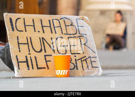 Monaco, Germania. 30th ago, 2022. Un cartello con la scritta "i'm Hungry - help please" si trova su un marciapiede del centro. Credit: Peter Kneffel/dpa/Alamy Live News Foto Stock