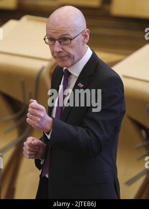 La foto del file datata 09/11/21 del vice primo ministro John Swinney aggiorna gli MSP su qualsiasi modifica alle restrizioni del Covid-19 nella camera di discussione del Parlamento scozzese a Edimburgo, in quanto l'estensione del beneficio Scottish Child Payment introdotto dai ministri Holyrood è una parte 'vitale' degli sforzi per affrontare il problema Costo della crisi vivente, ha detto John Swinney. Il vice primo ministro ha parlato come dimostrano i dati del governo scozzese da quando il pagamento, che va alle famiglie a basso reddito, è stato introdotto nel febbraio 2021, sono stati versati circa £84 milioni di euro. Data di pubblicazione: Martedì ago Foto Stock