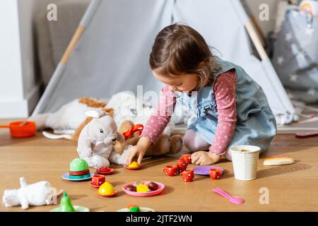 bambina che gioca a una festa con i giocattoli a casa Foto Stock
