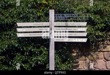 Segnaletica in legno nei terreni delle rovine di Fountains Abbey Cistercense Monastery, North Yorkshire, Inghilterra, UK. Foto Stock