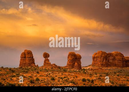 Nuvole temporeggiate al tramonto su Balanced Rock nel Parco Nazionale di Arches, Moab, Utah. Foto Stock