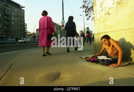 Bucarest, Romania, 1992. Giovane con grave handicap che si accattava per strada. Foto Stock