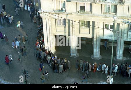 Bucarest, Romania, gennaio 1990. Meno di un mese dopo la rivoluzione anticomunista del dicembre 1989, la gente rimane ancora in lunghe file per ottenere la presa dei generi alimentari di base. Il sistema economico socialista centralizzato ha creato scarsità e fame. Foto Stock