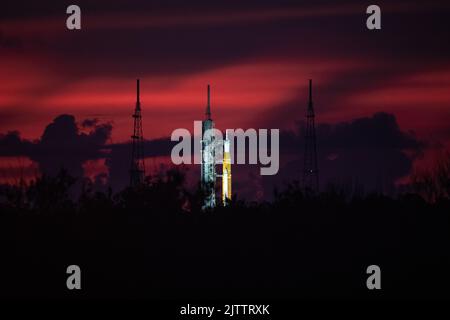 Cape Canaveral, Florida, Stati Uniti. 22nd ago, 2022. Una vista all'alba del sistema spaziale di lancio della NASA e della navicella spaziale Orion per Artemis i sul pad al Launch Complex 39B al Kennedy Space Center della NASA in Florida. La prima di una serie di missioni sempre più complesse, Artemis i fornirà una base per l'esplorazione dello spazio profondo umano e dimostrerà il nostro impegno e la nostra capacità di estendere la presenza umana alla Luna e oltre. L'obiettivo primario di Artemis i è quello di testare accuratamente i sistemi integrati prima delle missioni con equipaggio facendo funzionare la navicella spaziale in un ambiente di spazio profondo, testando il calore di Orion Foto Stock