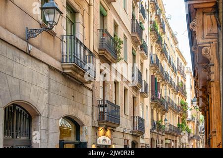 Vecchia parete piena di balconi in una strada stretta nel centro della città. Una vista dell'architettura classica nel quartiere del centro cittadino. Foto Stock