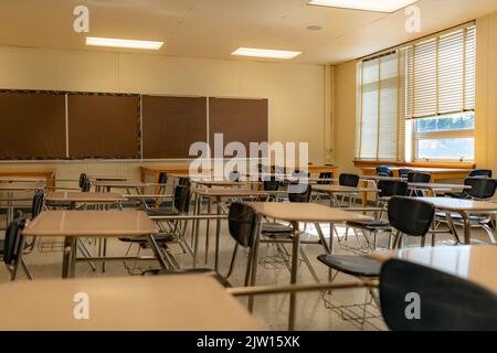 Esempio di un'aula scolastica americana non descrittiva vuota con scrivanie. Foto Stock